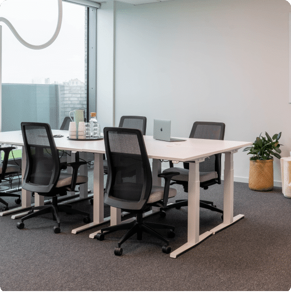 Modern private office meeting room with ergonomic chairs and natural light.