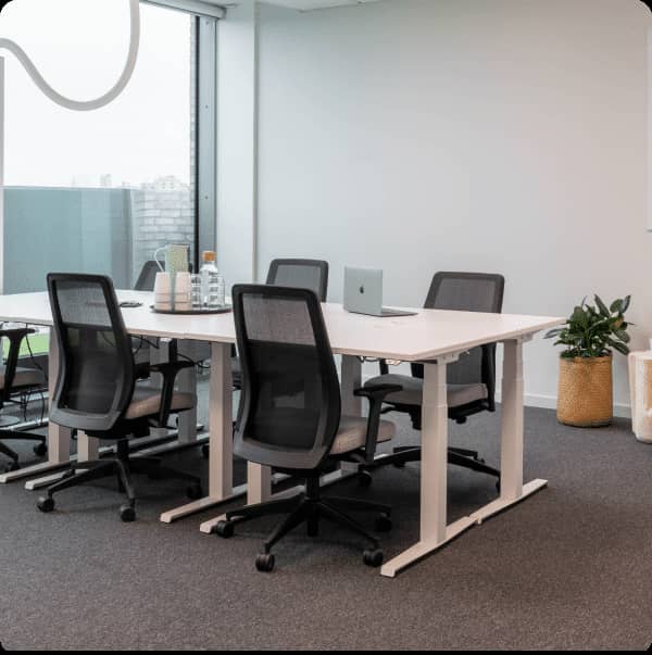 Modern private office meeting room with ergonomic chairs and natural light.