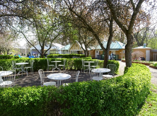 Charming outdoor meeting space at Rosendals Wärdshus with white tables for networking events.