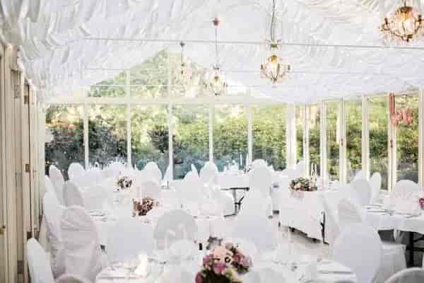 Elegant banquet hall with floral centerpieces, perfect for weddings and formal events.