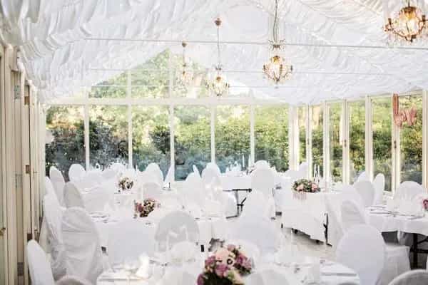 Elegant banquet hall with floral centerpieces, perfect for weddings and formal events.