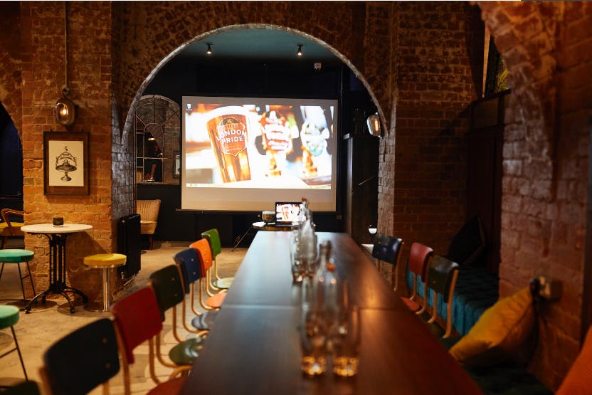 Stylish Firefly Cellar Bar event space with long table, perfect for meetings and gatherings.