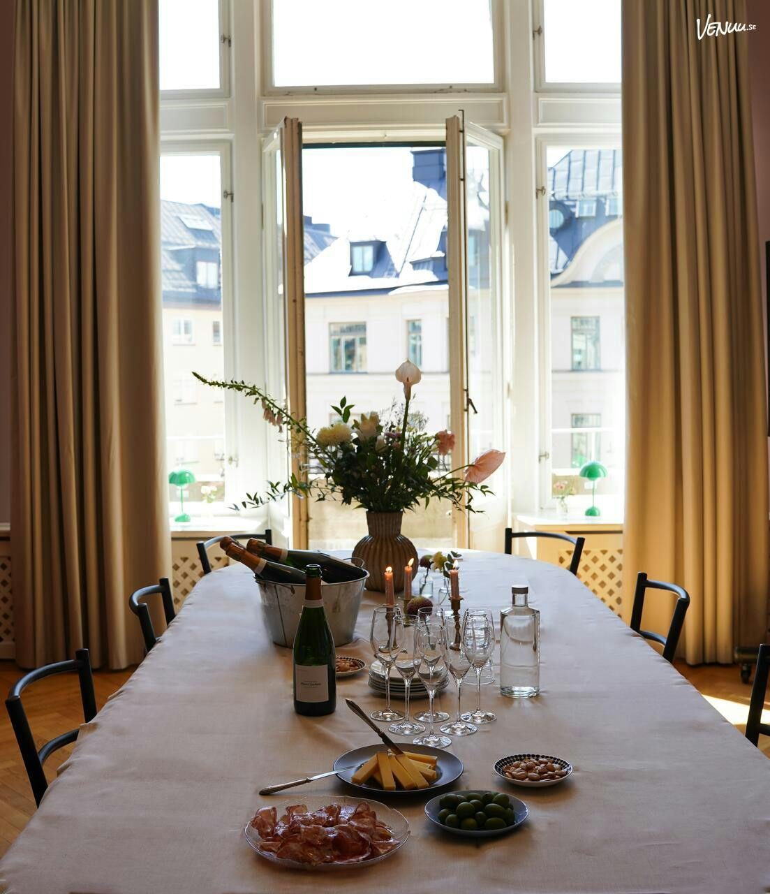 Elegant meeting space at The Sparrow Hotel with floral centerpiece and natural light.