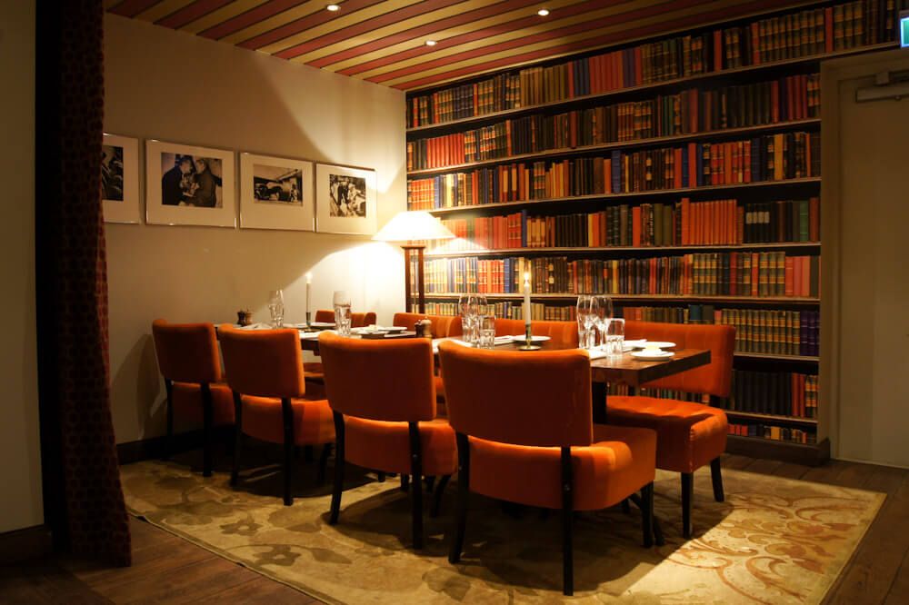 Stylish meeting space with orange chairs, ideal for executive meetings in India.