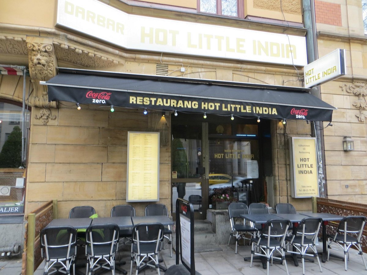 Casual dining restaurant entrance in India with outdoor seating for networking events.