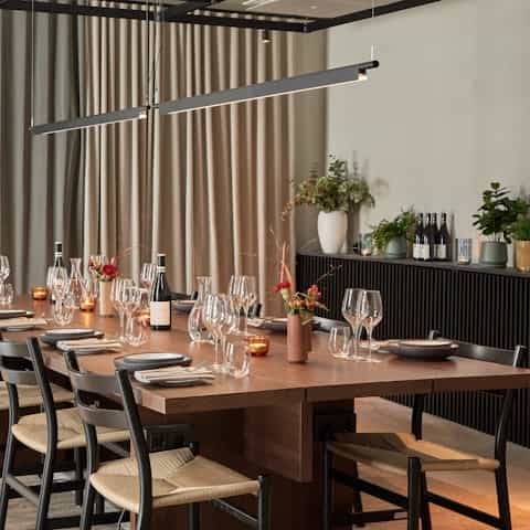 Elegant dining table setup for intimate corporate dinner or networking event.