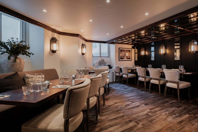 Sophisticated dining room with warm lighting for intimate corporate events and networking dinners.