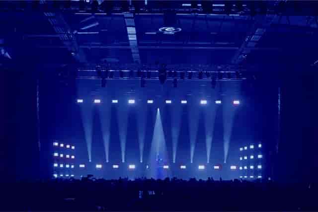 "Annexet event space with blue-lit stage for dynamic presentations and performances."