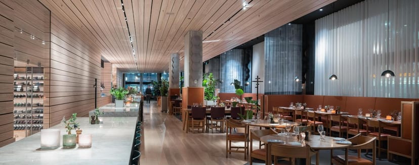 Modern restaurant in Nordic Light Hotel with warm wood accents, ideal for events.