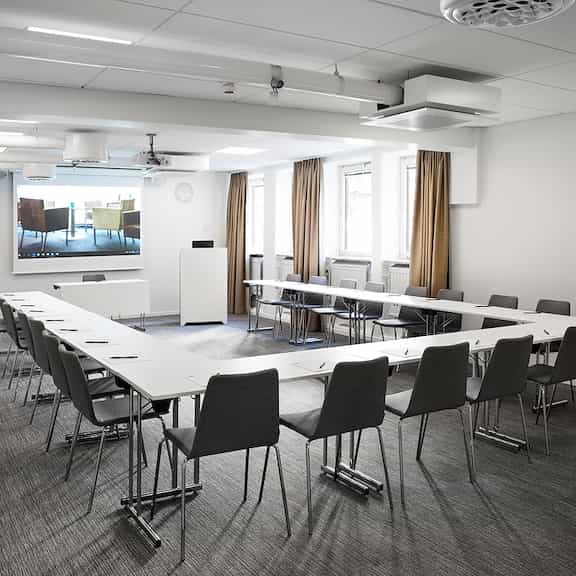 Meeting room with U-shaped seating and large screen at Best Western Kom Hotel Stockholm.