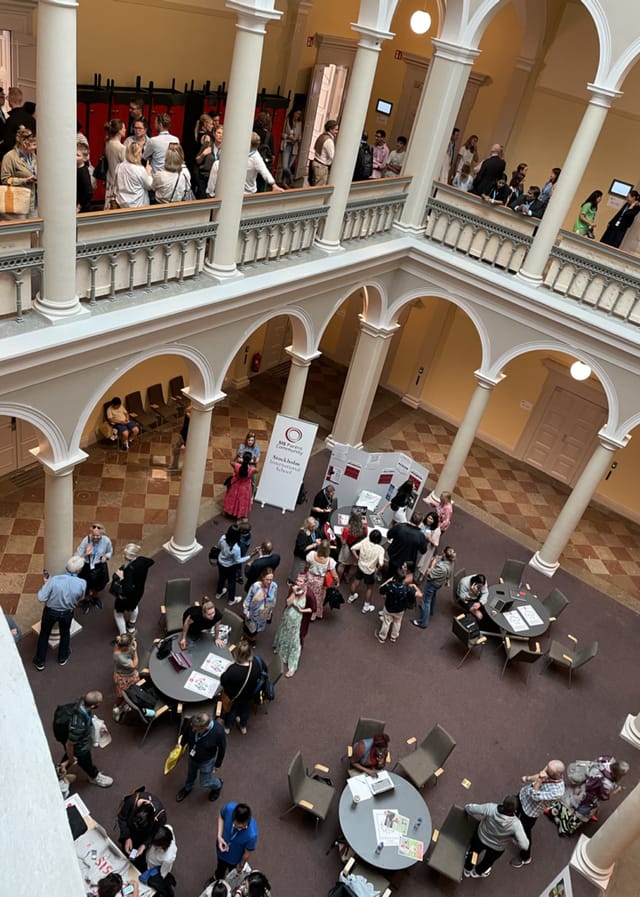 "Norra Latin atrium bustling with attendees at a middle school networking event."