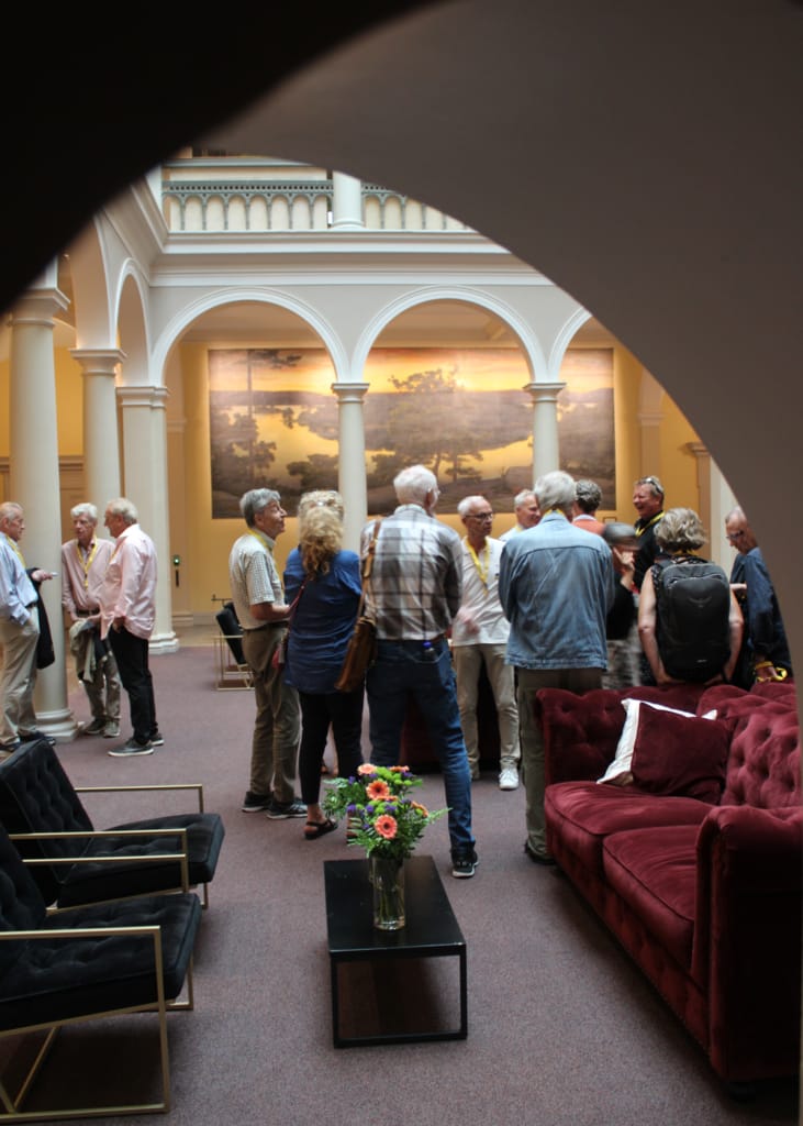 Lively networking event at Stockholm Norra Latin with artistic backdrop.