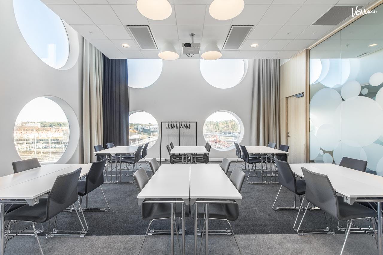 Modern conference center with circular windows, ideal for workshops and meetings.