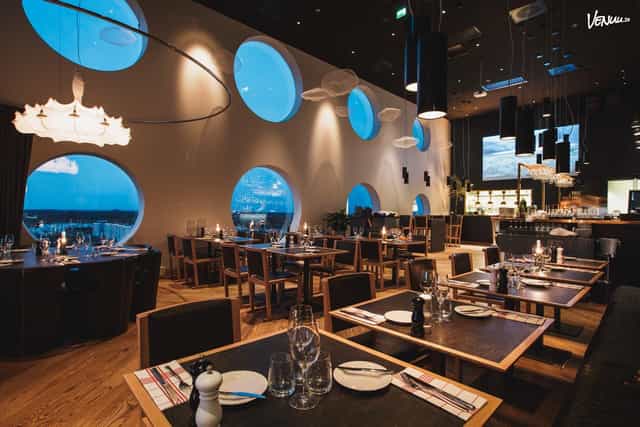 Modern restaurant with circular windows at Quality Hotel™ Strawberry Arena for events.