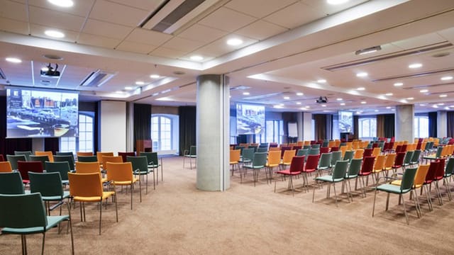 Conference room with colorful chairs for engaging meetings at Elite Hotel Marina Tower.