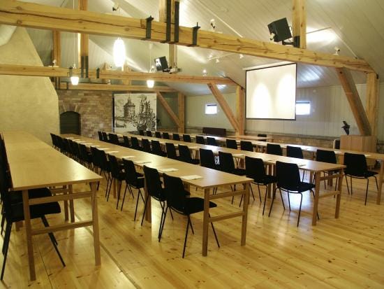 Versatile meeting space at Restaurant Pansarbatteriet with wooden beams, ideal for workshops.
