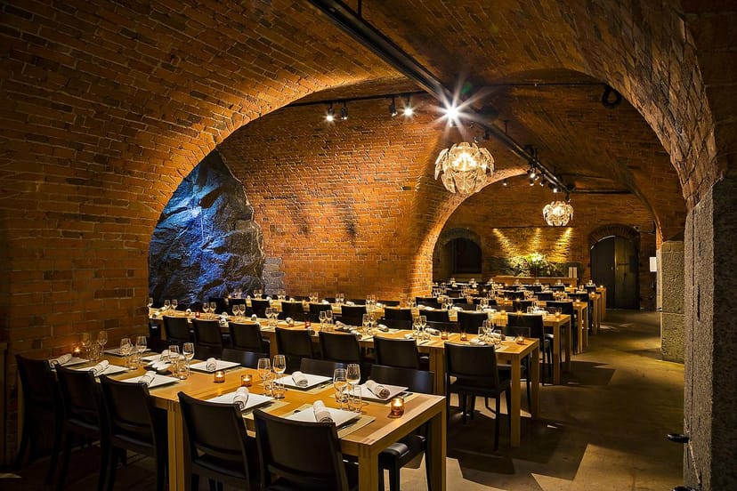 Elegant event space at Bistro Kastellet with rustic arches, perfect for corporate dinners.