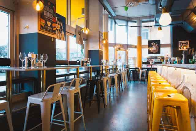 Modern Urban Deli venue with high tables, ideal for casual meetings and events.