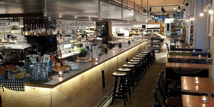 Modern Urban Deli venue with sleek bar, ideal for cocktail receptions and networking events.