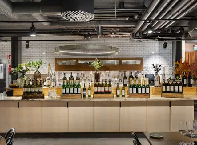 Wine bar at The Winery Hotel with elegant wine display, perfect for events and gatherings.