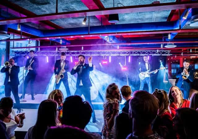 Live band performing at Café in Garnisonen, vibrant atmosphere for events and entertainment.