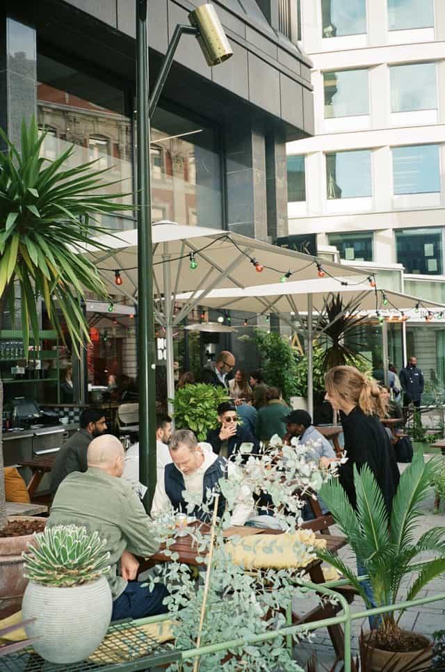 Outdoor patio at Hobo Hotel, lush greenery for casual networking events and mixers.
