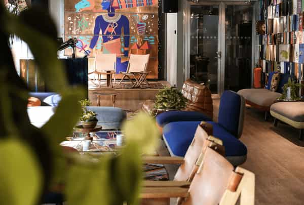 Vibrant Hobo Hotel lobby with eclectic decor, ideal for informal meetings and gatherings.