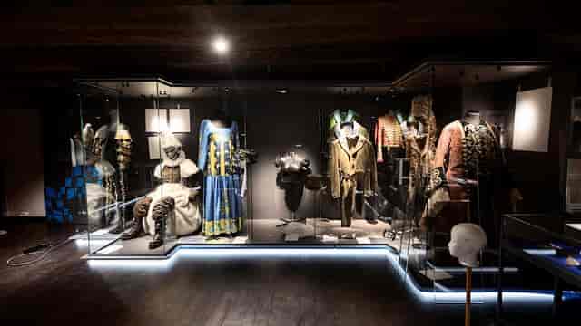 Historical costumes display at The Performing Arts Museum for themed events.