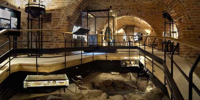 Royal Palace museum event space with exposed brick arches for workshops and gatherings.