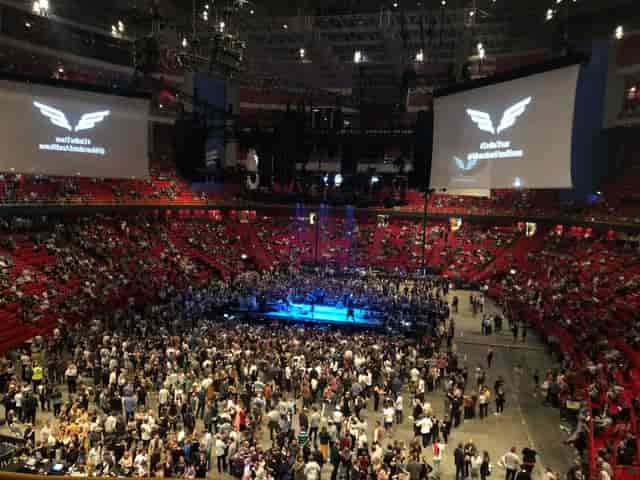 Packed Avicii Arena concert hall with vibrant staging and audiovisual setups for events.