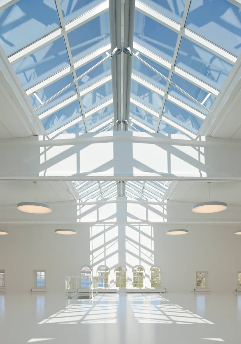 Bright event space with glass ceiling, perfect for conferences and networking.