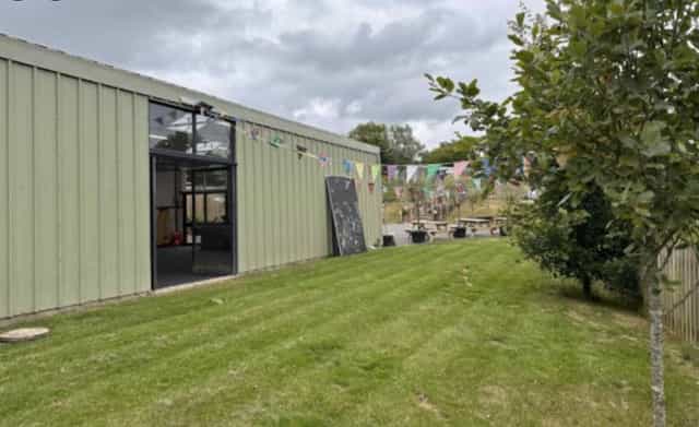 Versatile UpCountry Events Barn with festive bunting, perfect for outdoor gatherings and workshops.