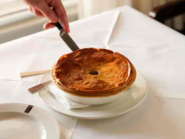 Elegant pie with golden crust at Lasdun Restaurant for catered events.
