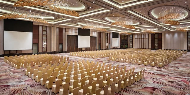 Conference hall in Kerry Hotel Pudong, Shanghai with elegant decor and presentation screens.