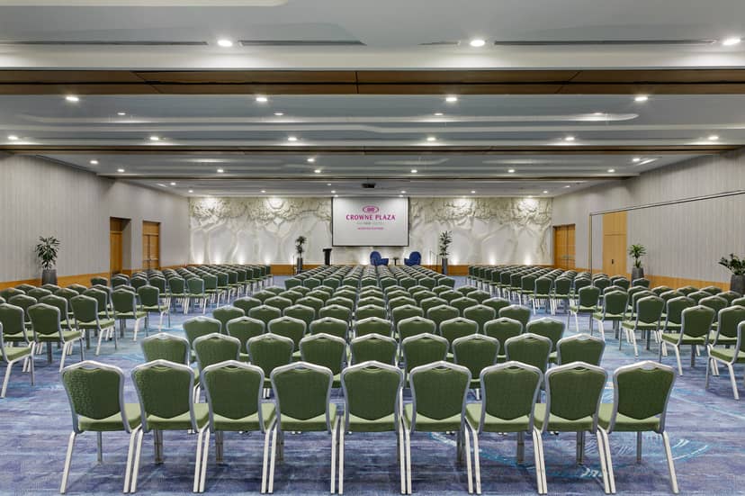 Conference room with green chairs for seminars at InterContinental Hotels Group.