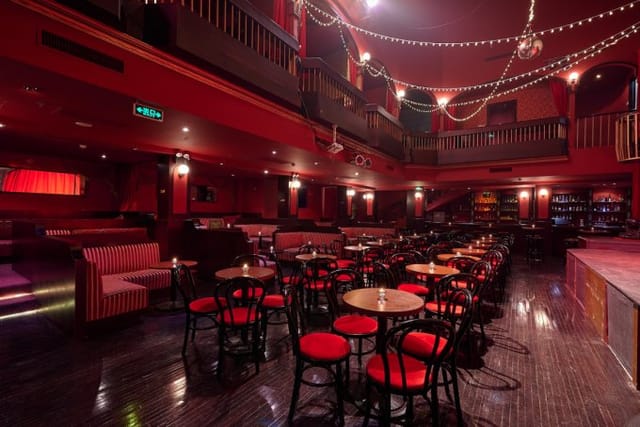Vibrant Pearl Room event space with red decor, ideal for cocktail receptions and gatherings.