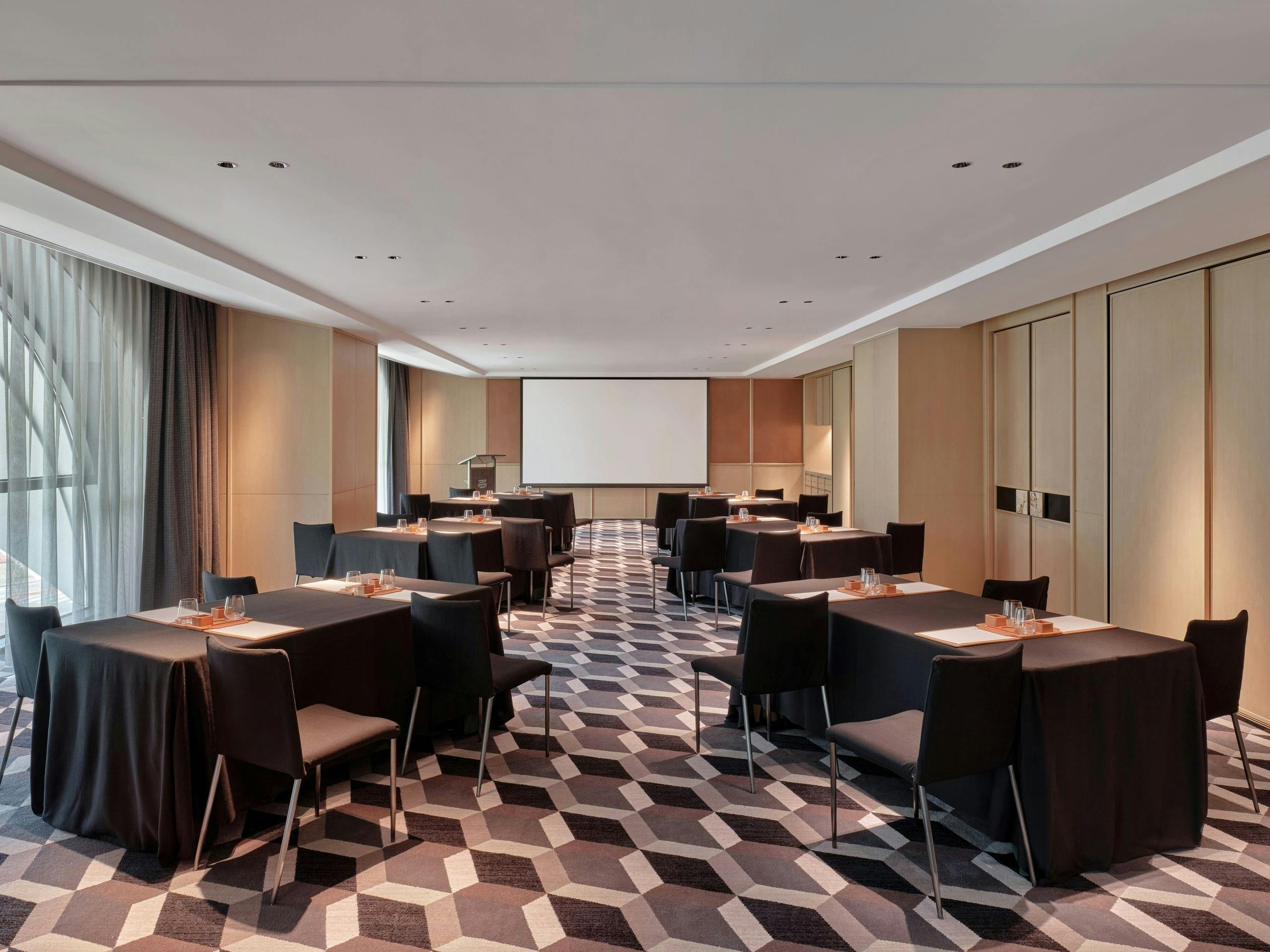 Meeting room with sleek tables and natural light at Shanghai Yacht Club for corporate events.