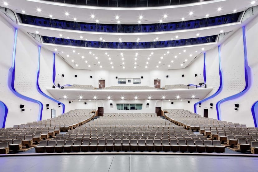 Modern auditorium with tiered seating, perfect for conferences and performances.