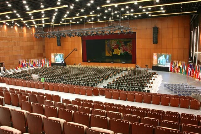 Spacious conference room with tiered seating for global events at National Convention Center.