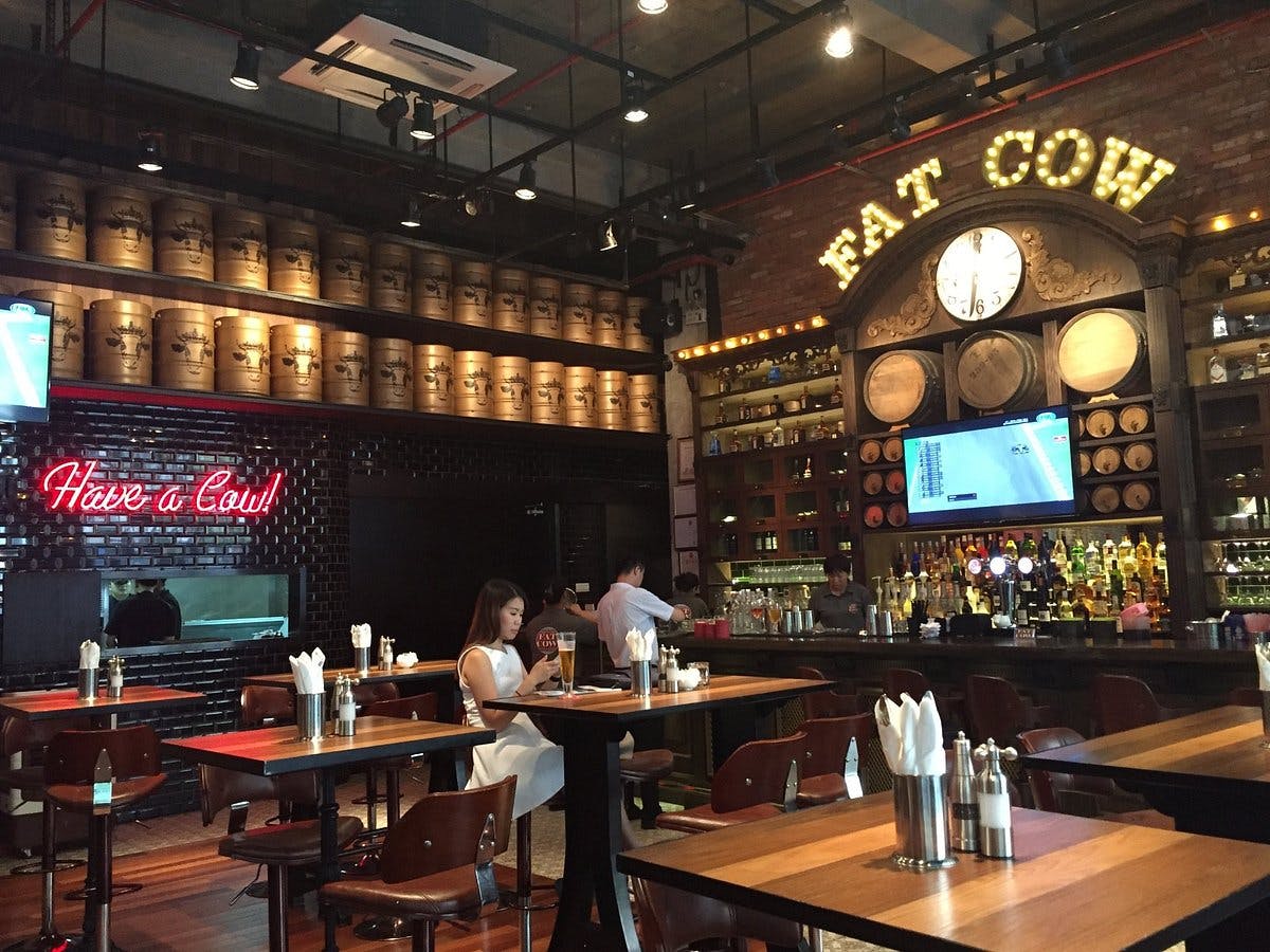 Stylish restaurant in Fat Cow with wooden tables, ideal for casual meetings and events.