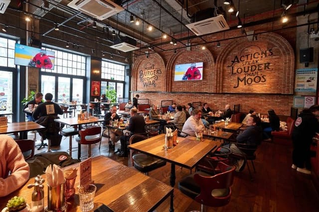 Vibrant Fat Cow restaurant with brick walls, ideal for casual meetings and events.
