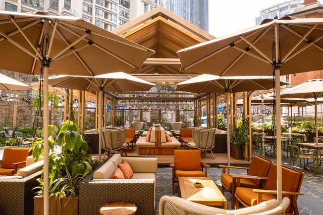 Stylish outdoor venue in D.O.C Shanghai for meetings and events with greenery and seating.