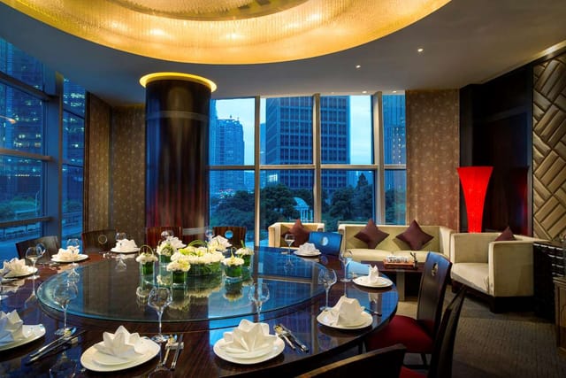Sophisticated dining space with round table for corporate events at Suntime Century Restaurant.