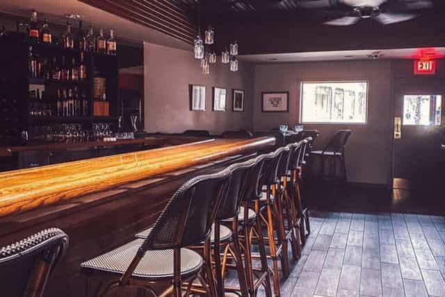 Main Floor Long Oak Bar in Shanghai Jazz, stylish wooden counter, ideal for networking events.