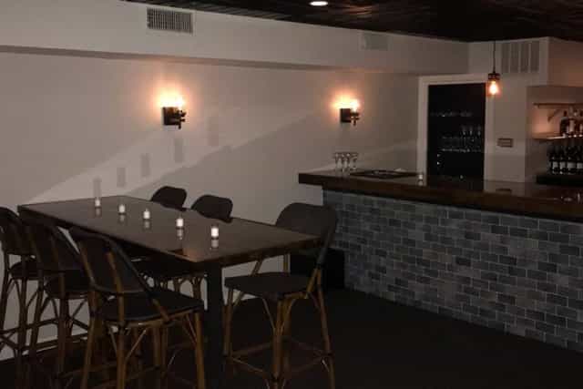 Main Floor Long Oak Bar in Shanghai Jazz, sleek bar, cozy event space for gatherings.