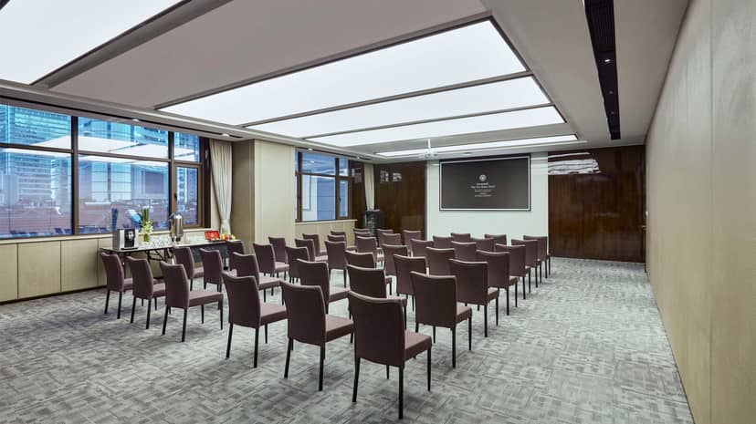 The One Meeting Room at Kempinski Shanghai, featuring a sleek presentation screen for corporate events.