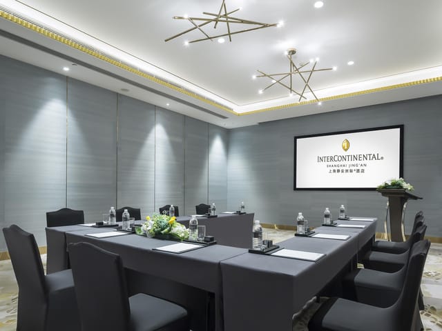 Modern W Hotels meeting room with central table, ideal for corporate events and conferences.