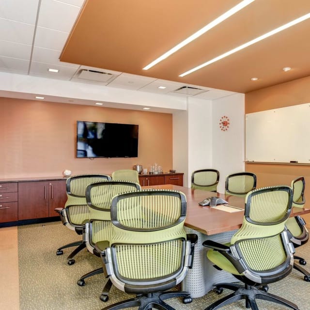 Modern conference room with sleek table, ideal for legal meetings and presentations.