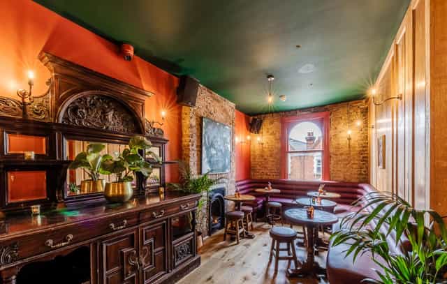 Cozy co-working space in Queen of The South Pub, ideal for networking events and gatherings.