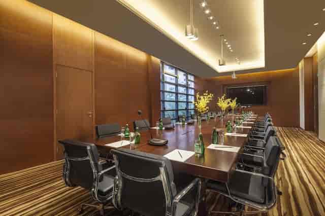 Modern conference room with wooden table, ideal for business meetings at Hotel Citadines.